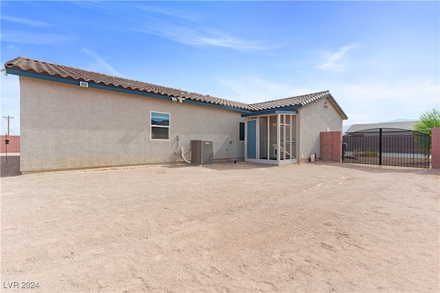 rear view of house featuring cooling unit