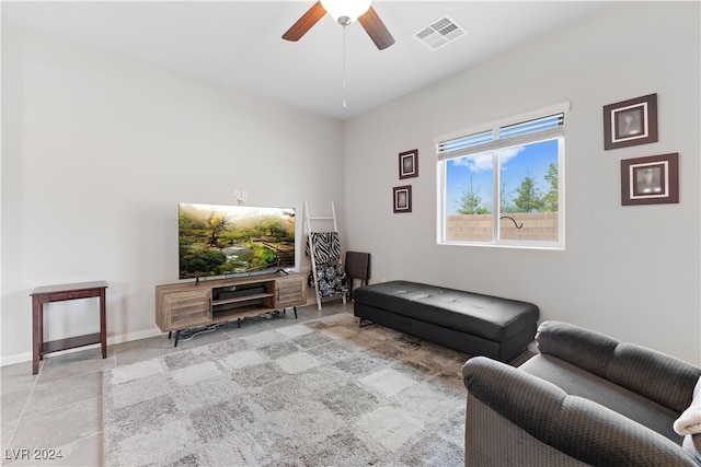 tiled living room with ceiling fan