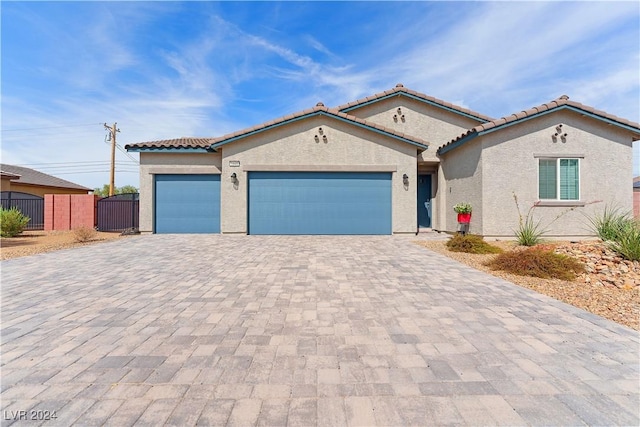 mediterranean / spanish-style home featuring a garage