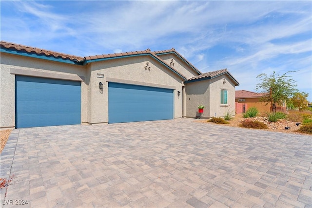 mediterranean / spanish home with a garage