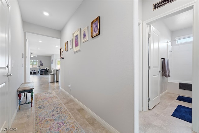 hall featuring light tile patterned flooring