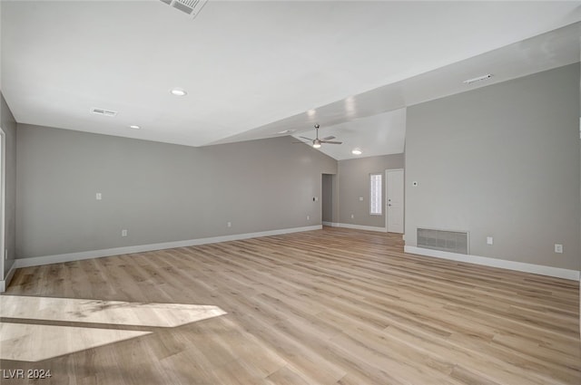 unfurnished room featuring lofted ceiling, visible vents, baseboards, a ceiling fan, and light wood finished floors