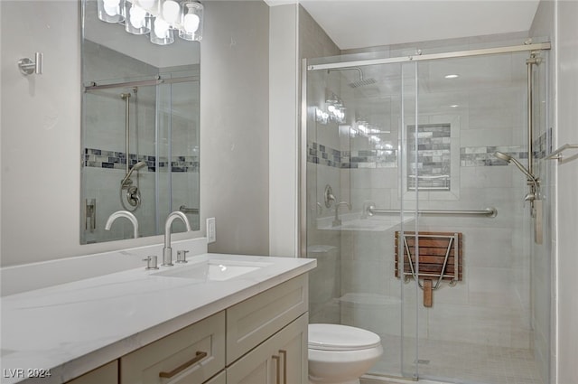 full bathroom with a shower stall, toilet, and vanity