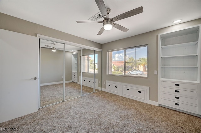 unfurnished bedroom featuring ceiling fan, baseboards, and light colored carpet