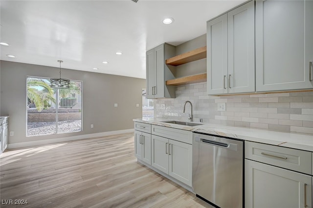 kitchen featuring dishwasher, light stone counters, gray cabinetry, open shelves, and a sink