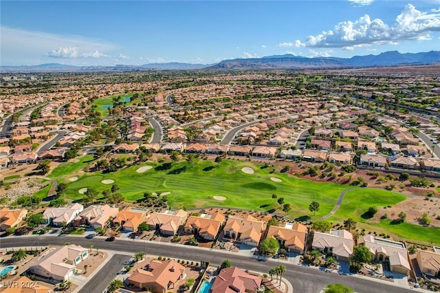 drone / aerial view with view of golf course, a residential view, and a mountain view