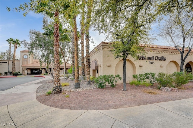 view of front of property featuring a tile roof and stucco siding