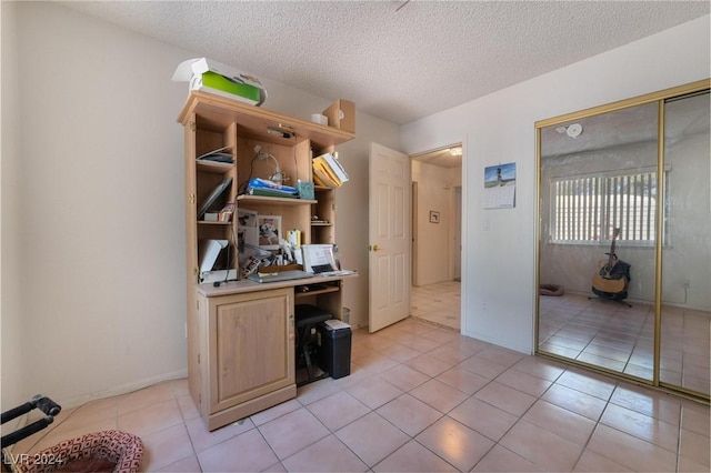 home office featuring a textured ceiling and light tile patterned floors