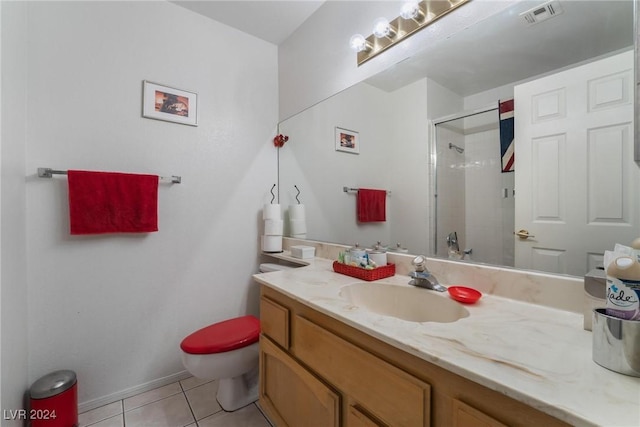 bathroom with visible vents, toilet, tile patterned flooring, a tile shower, and vanity