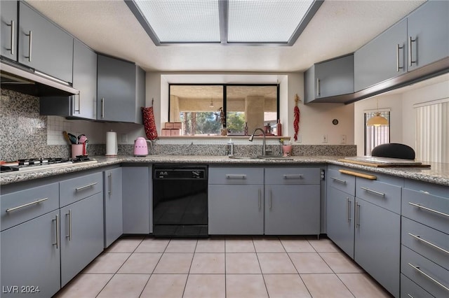 kitchen featuring under cabinet range hood, gas cooktop, gray cabinets, and dishwasher