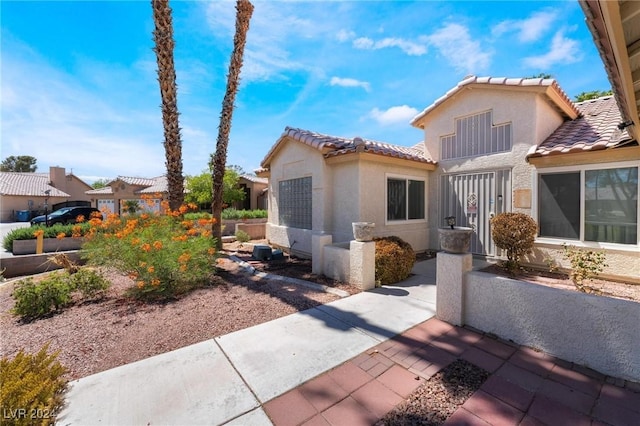 exterior space featuring a tile roof and stucco siding