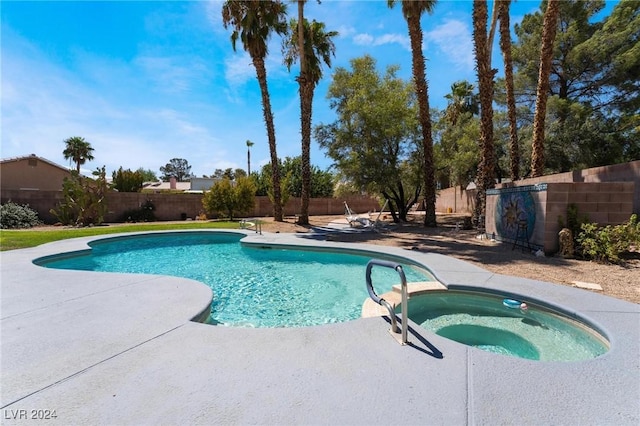 view of swimming pool with a pool with connected hot tub, a fenced backyard, and a patio