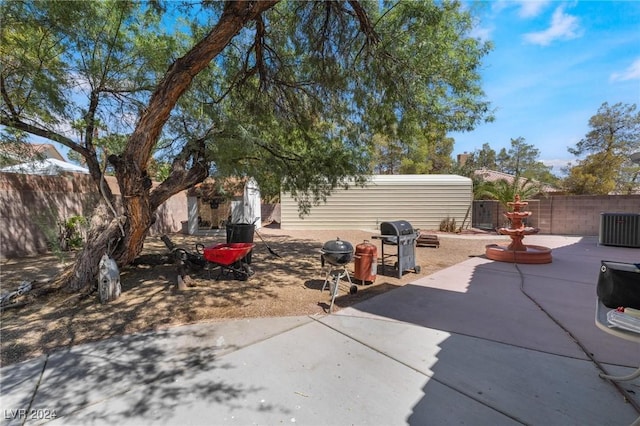 view of patio / terrace featuring central AC, a grill, and a fenced backyard