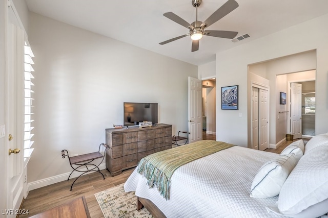 bedroom with light wood finished floors, a closet, visible vents, and baseboards