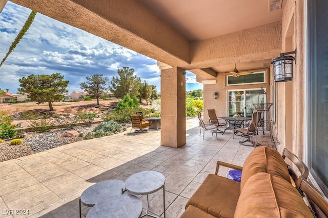 view of patio with outdoor dining space, visible vents, and a ceiling fan