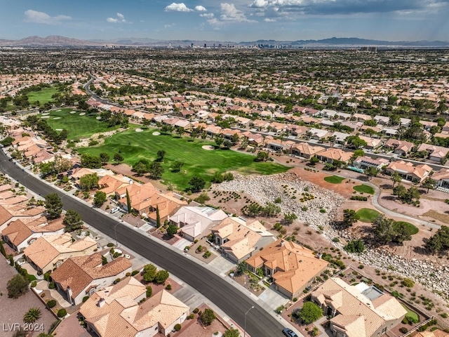 drone / aerial view with view of golf course, a residential view, and a mountain view