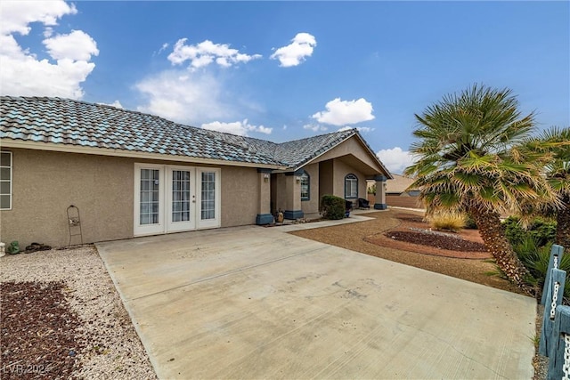 rear view of house featuring french doors and a patio area