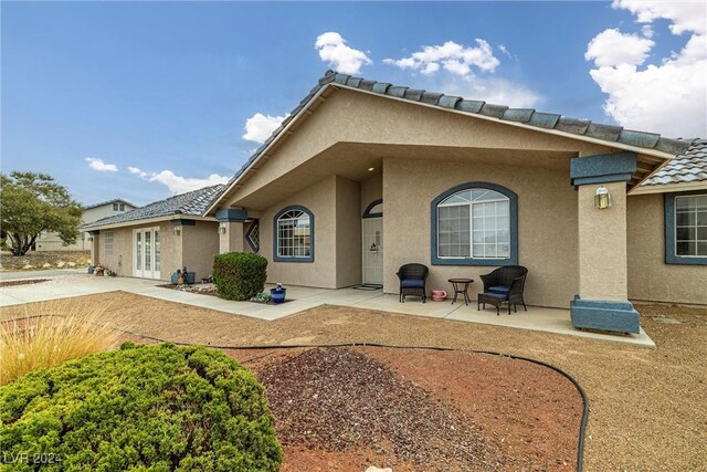 back of house with french doors and a patio