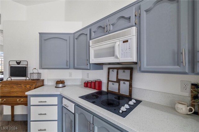 kitchen with white appliances and gray cabinets