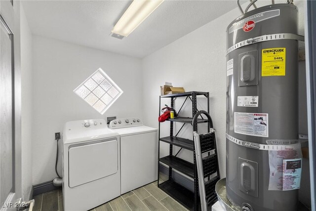 laundry area featuring independent washer and dryer and secured water heater