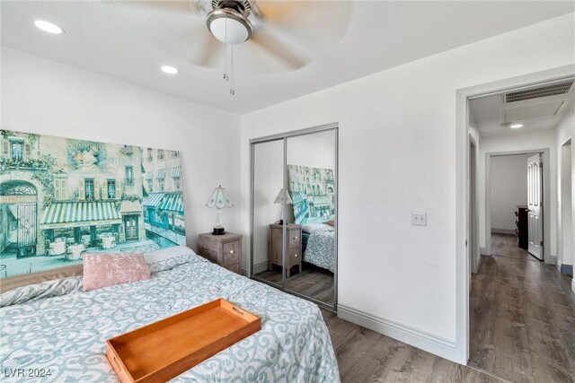 bedroom featuring a closet, dark wood-type flooring, and ceiling fan