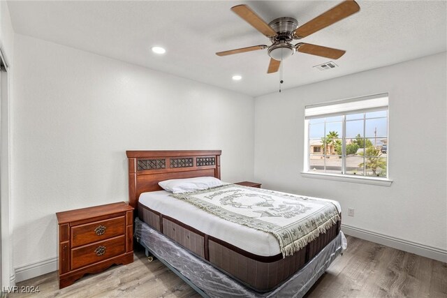 bedroom with ceiling fan and wood-type flooring