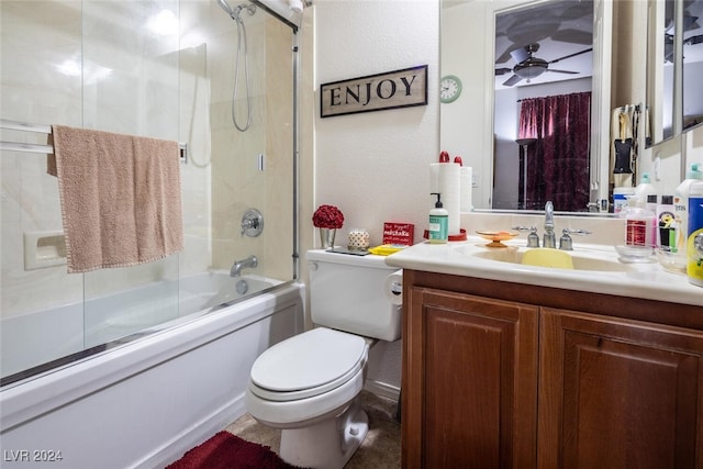 full bathroom featuring combined bath / shower with glass door, vanity, toilet, and ceiling fan