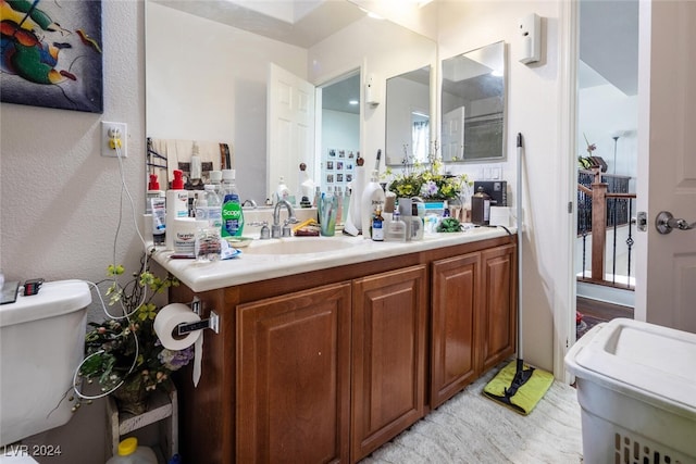 bathroom featuring vanity and toilet