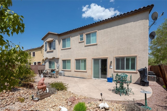 back of house with a patio and central AC