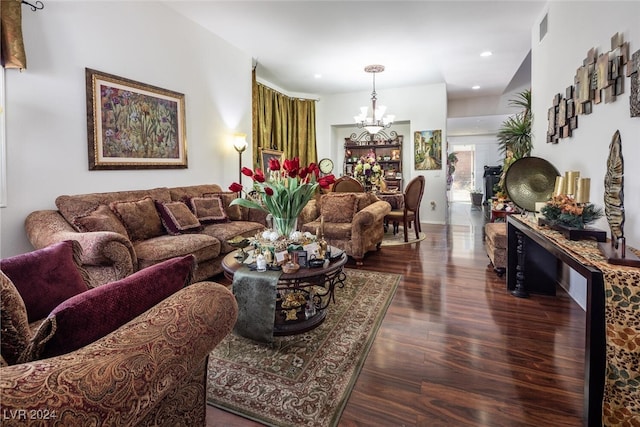 living room with a notable chandelier and dark hardwood / wood-style floors