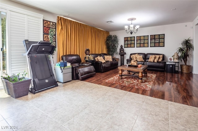 living room featuring an inviting chandelier and hardwood / wood-style floors