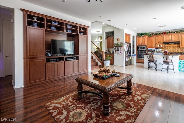 living room featuring hardwood / wood-style floors and a notable chandelier