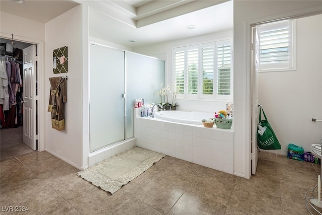 bathroom featuring shower with separate bathtub and tile patterned flooring