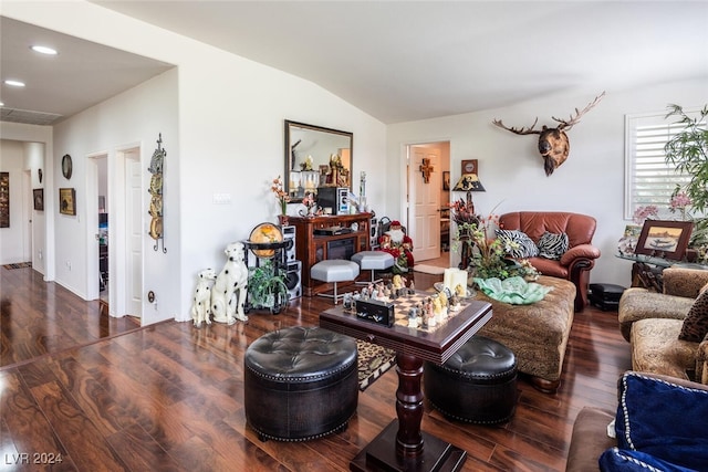 living room featuring lofted ceiling and dark hardwood / wood-style flooring