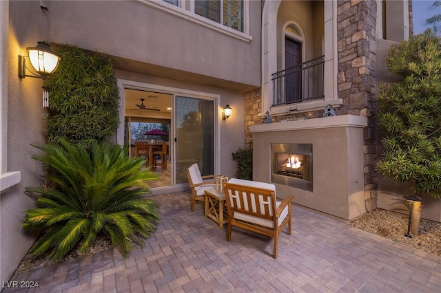 view of patio with an outdoor fireplace