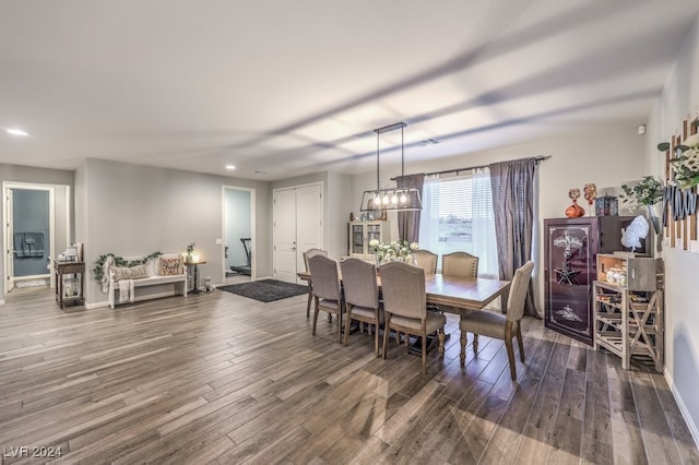 dining space with an inviting chandelier and wood-type flooring