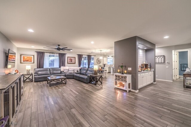 living room featuring ceiling fan, hardwood / wood-style flooring, and a wealth of natural light