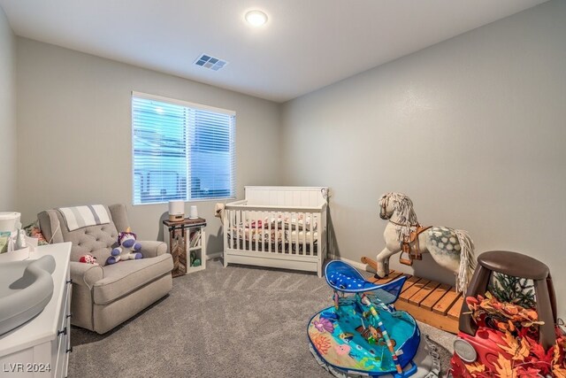 bedroom with a crib and carpet floors