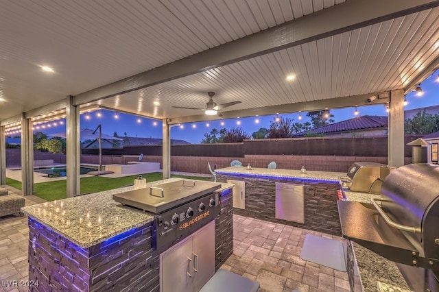 view of patio featuring ceiling fan, an outdoor kitchen, and area for grilling