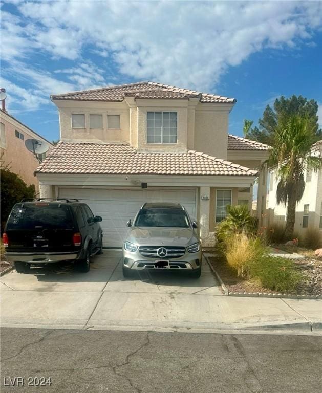 mediterranean / spanish house with a garage