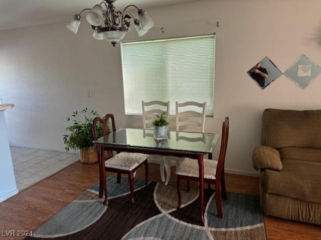 dining area featuring an inviting chandelier and wood-type flooring