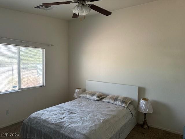 bedroom featuring ceiling fan and carpet