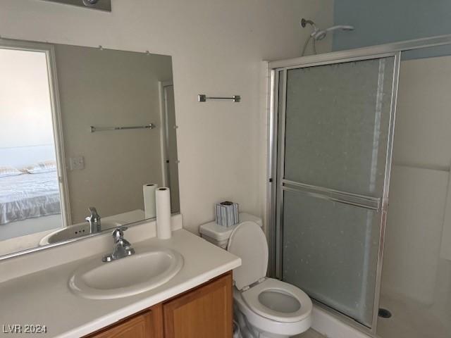 bathroom with vanity, toilet, and walk in shower