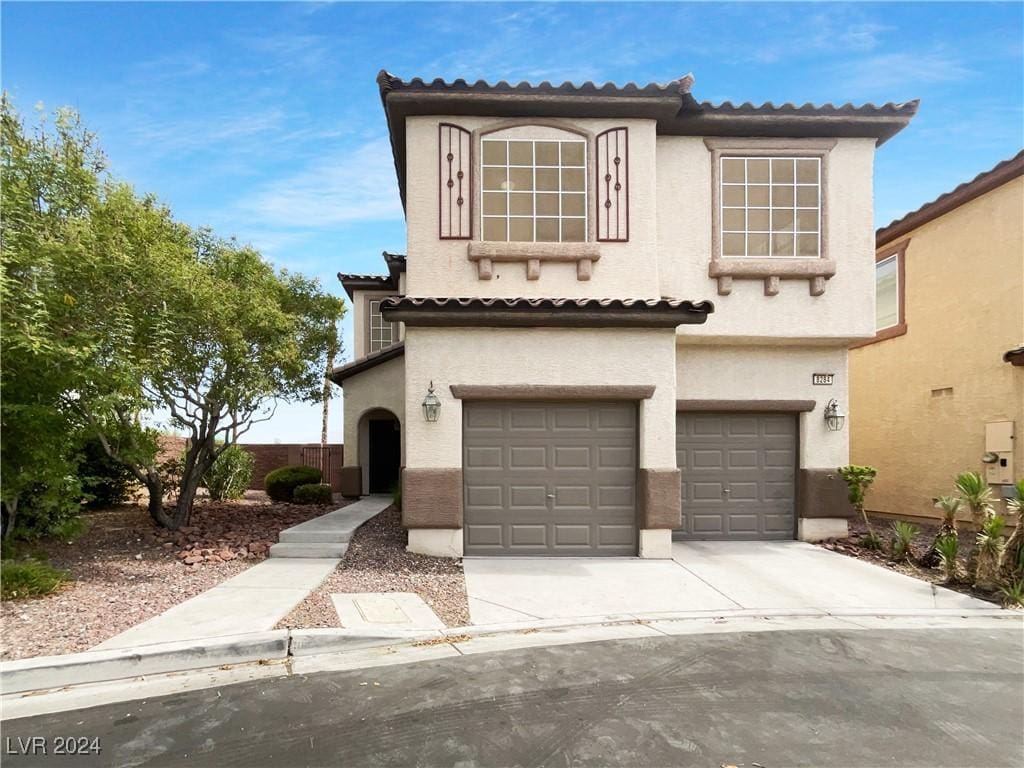 mediterranean / spanish home featuring a garage