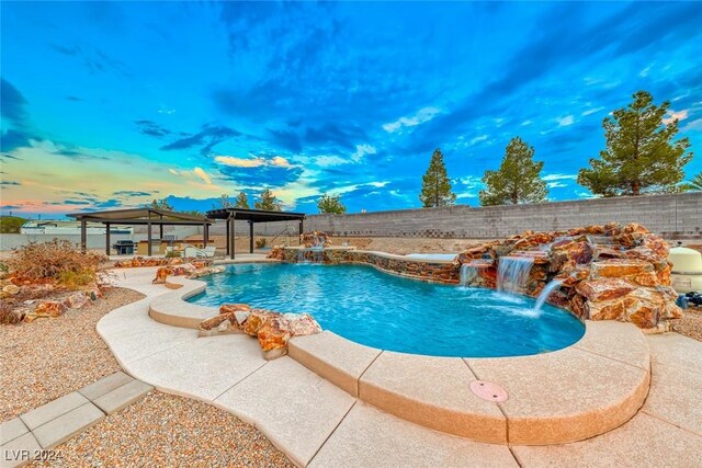 view of swimming pool featuring pool water feature, a patio, and a gazebo