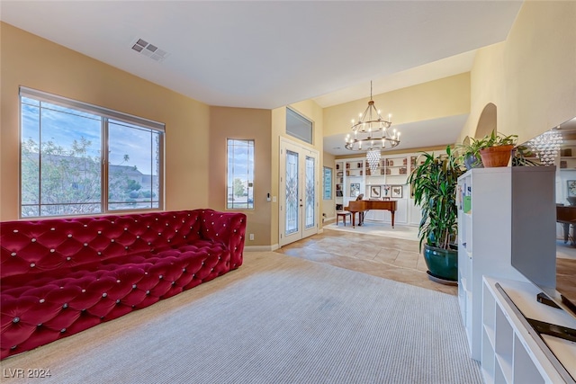 living room featuring an inviting chandelier and light carpet