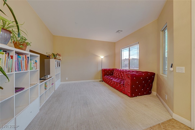 living area featuring light carpet