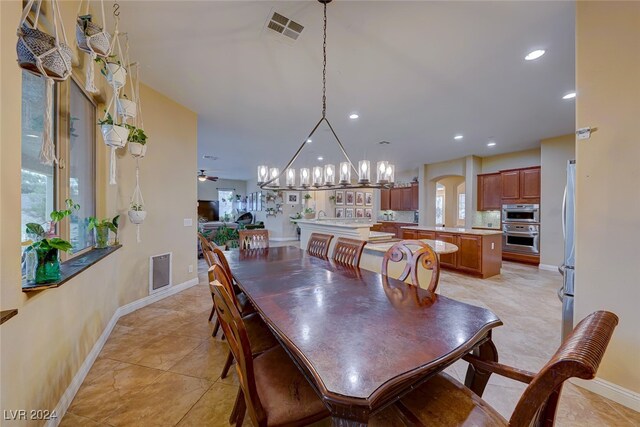 dining room with ceiling fan and light tile patterned floors