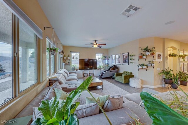 living room featuring ceiling fan and light wood-type flooring