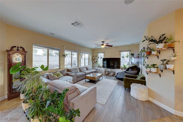 living room featuring ceiling fan and light hardwood / wood-style floors